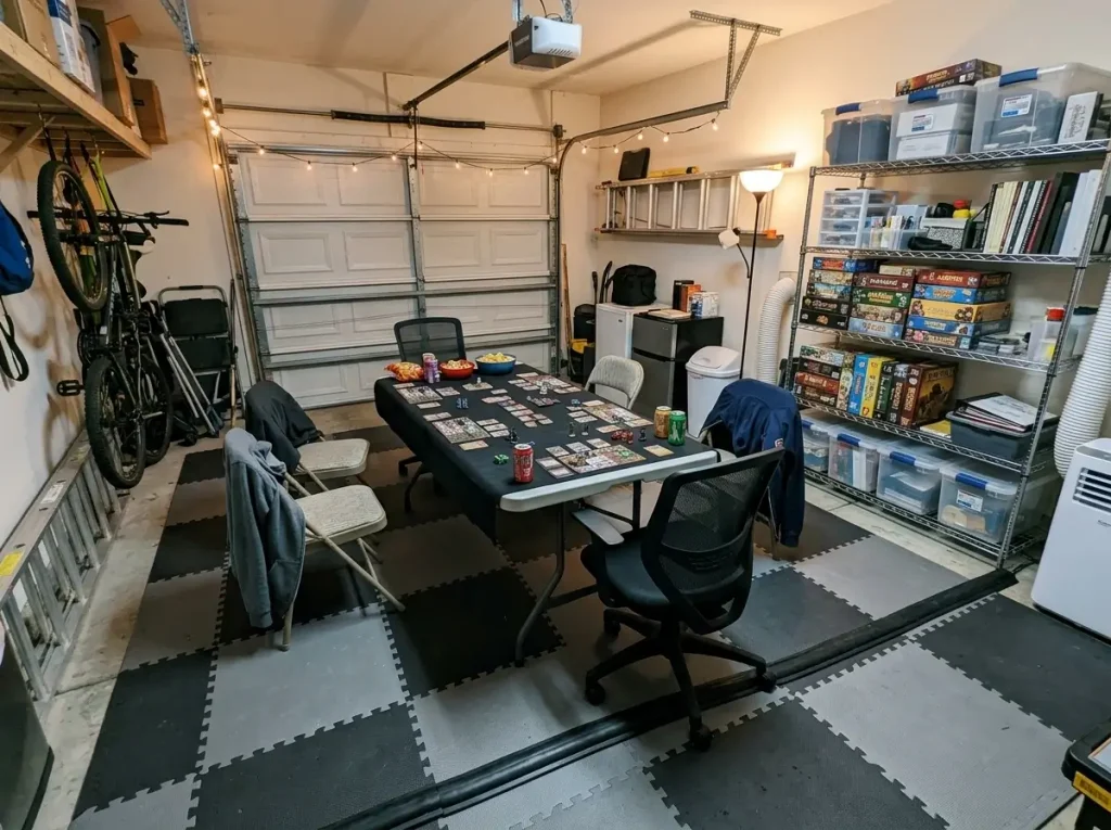 Foam floor mats and metal shelving showcasing diy small craft room ideas in a converted garage game room.